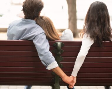 woman and man hold husband on bench