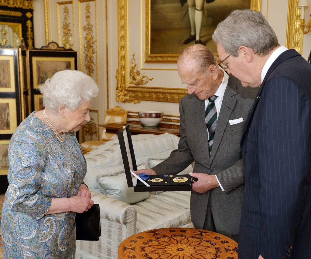 Queen Elizabeth and Prince Philip presenting honour