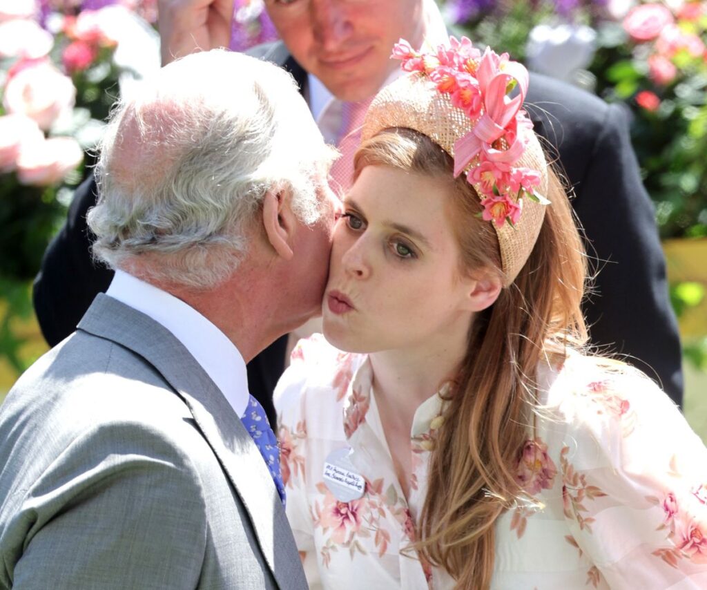 Princess Beatrice kissing King Charles on the cheek.