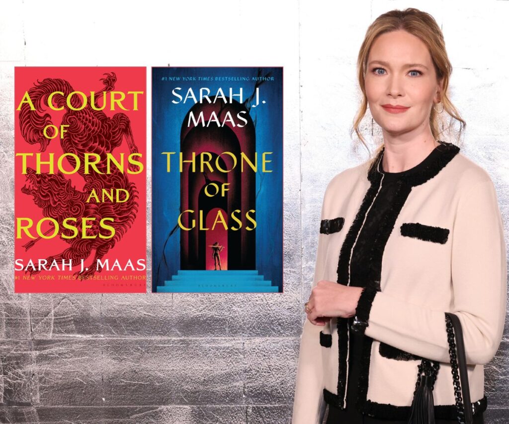 Romantasy author Sarah J Maas smiles in a nice tan and black suit with her two books A Court of Thorns and Roses and Throne of Glass