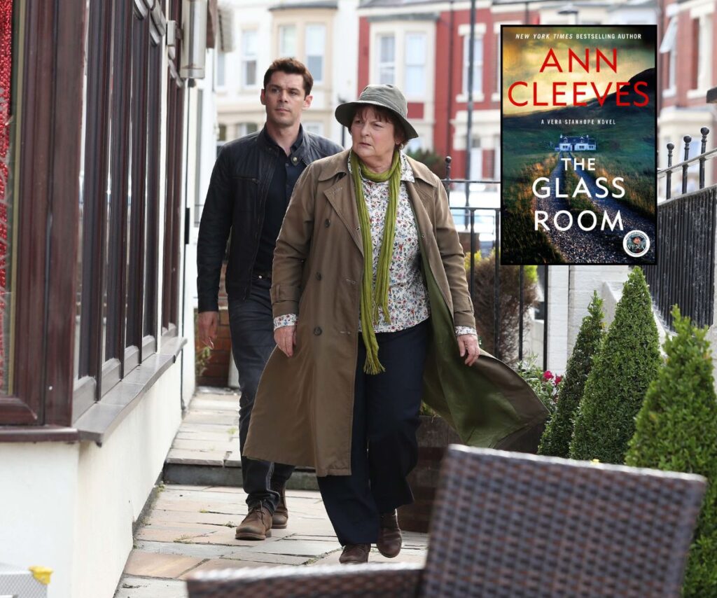 Vera on set, wearing a green scarf and hat. The book by Ann Cleeves is also pictured.