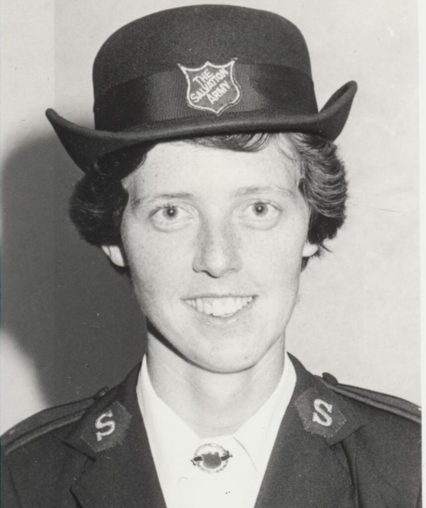 An early, black and white, photo of Miriam, smiling in her Salvos uniform