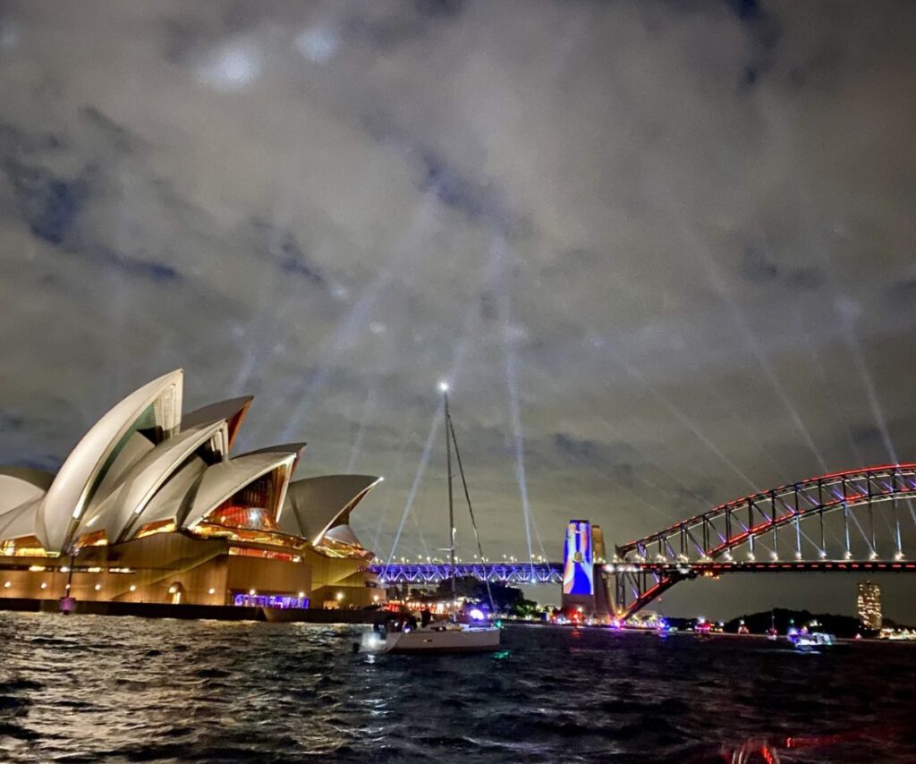 The Opera House and Harbour Bridge are lit up for Vivid