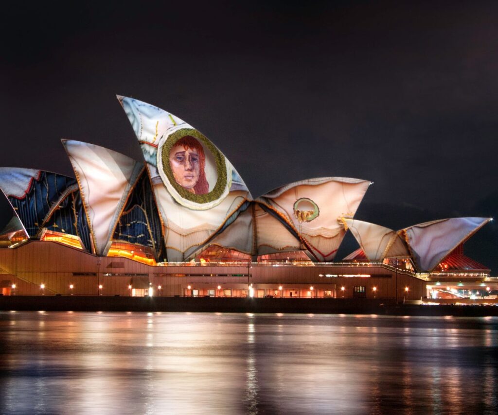 the Opera House sails wrapped in swaths of Julia Gutman's textural work, including face of woman for Vivid Sydney 2024