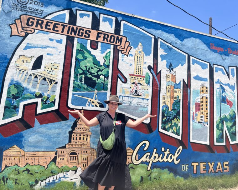 woman in front of Austin mural