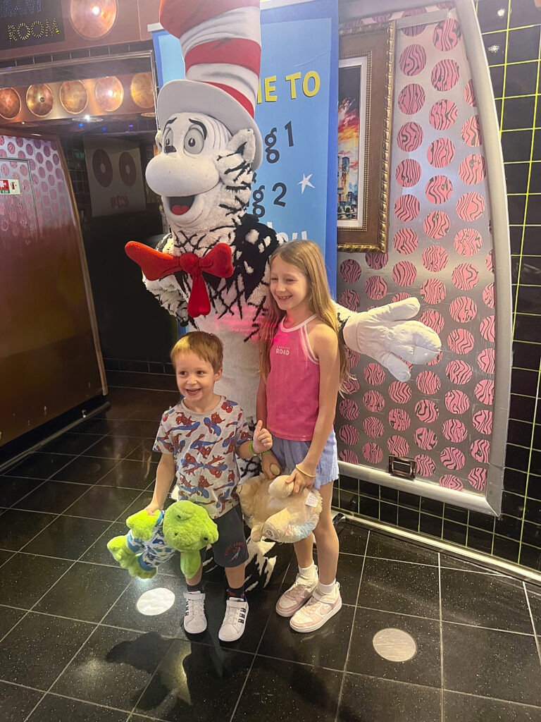 kids posing for a pic with a Dr Seuss character on a cruise 