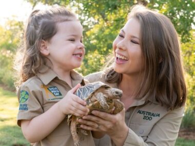 Bindi Irwin holds a turtle smiling at her daughter, revealing her secret tattoo