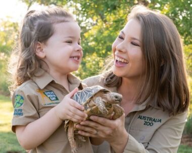 Bindi Irwin holds a turtle smiling at her daughter, revealing her secret tattoo