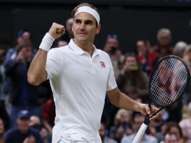 Roger Federer in tennis gear making a triumphant fist