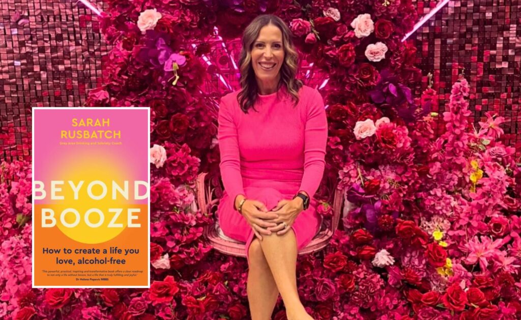 Dry July helper sobriety coach Sarah Rusbatch dazzles in pink beside her best-selling book Beyond Booze