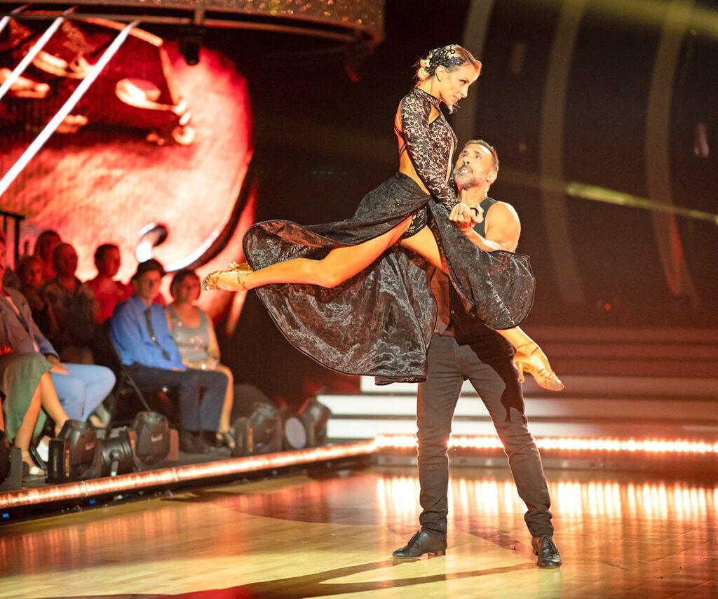 Adam and dancing partner performing on dancing with the stars