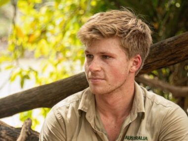 Robert Irwin wears khaki looks to the left