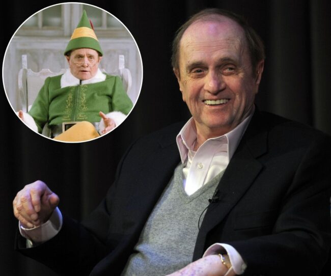 Elf star Bob Newhart smiles in black jacket, gray vest and white button up shirt