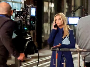 Reese Witherspoon looks upset on the phone filming for Morning Wars