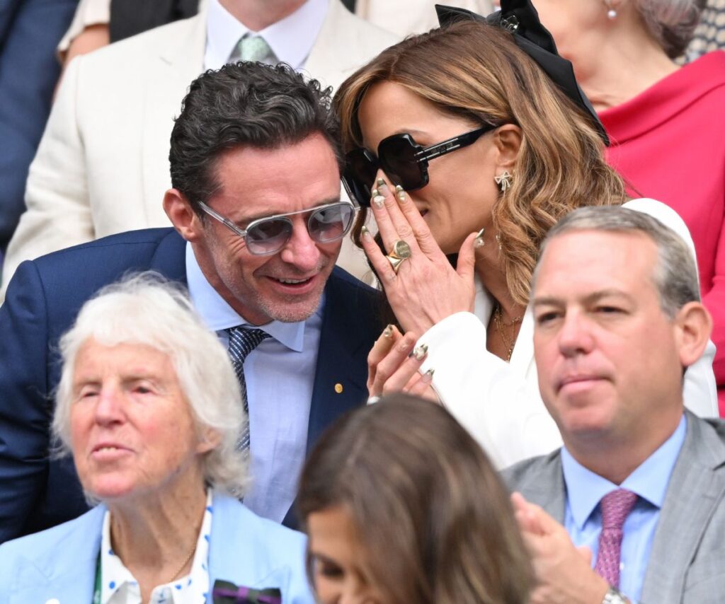 Kate was seen whispering into Hugh's ear during the match. 