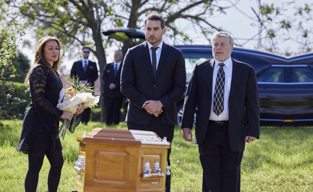 Eden, Cash and his father Gary stand in front of the coffin at Felicity's funeral