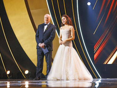 Ray Meagher and Kate Ritchie stand on the stand at the Logie Awards 2024 to present the Bert Newton award