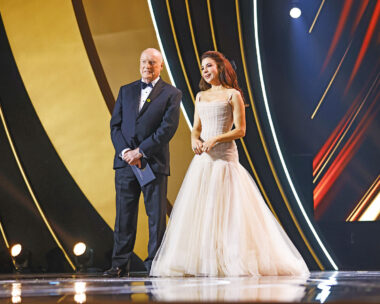 Ray Meagher and Kate Ritchie stand on the stand at the Logie Awards 2024 to present the Bert Newton award