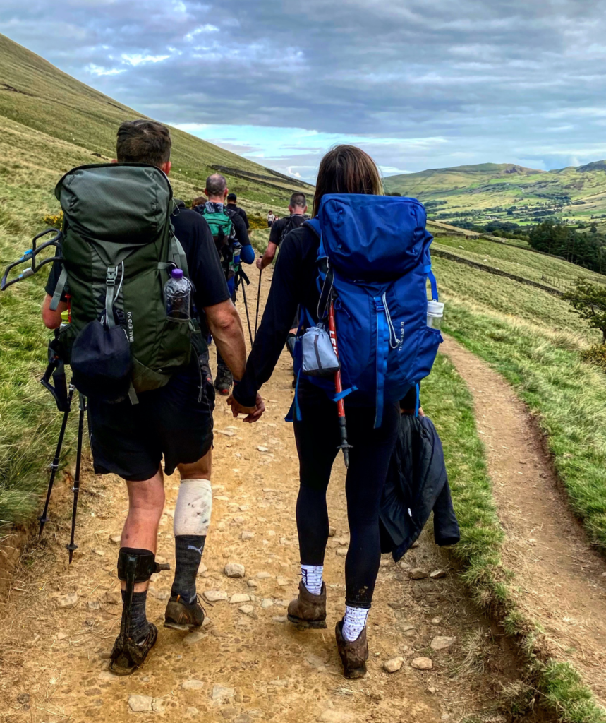 Lois and Ed holding hands while climbing 