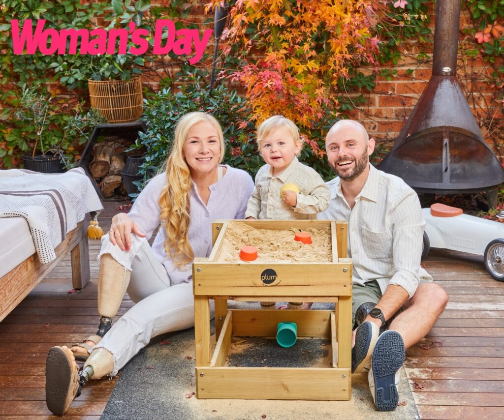 Vanessa Low with son Matteo and husband Scott Reardon, seated in a garden.