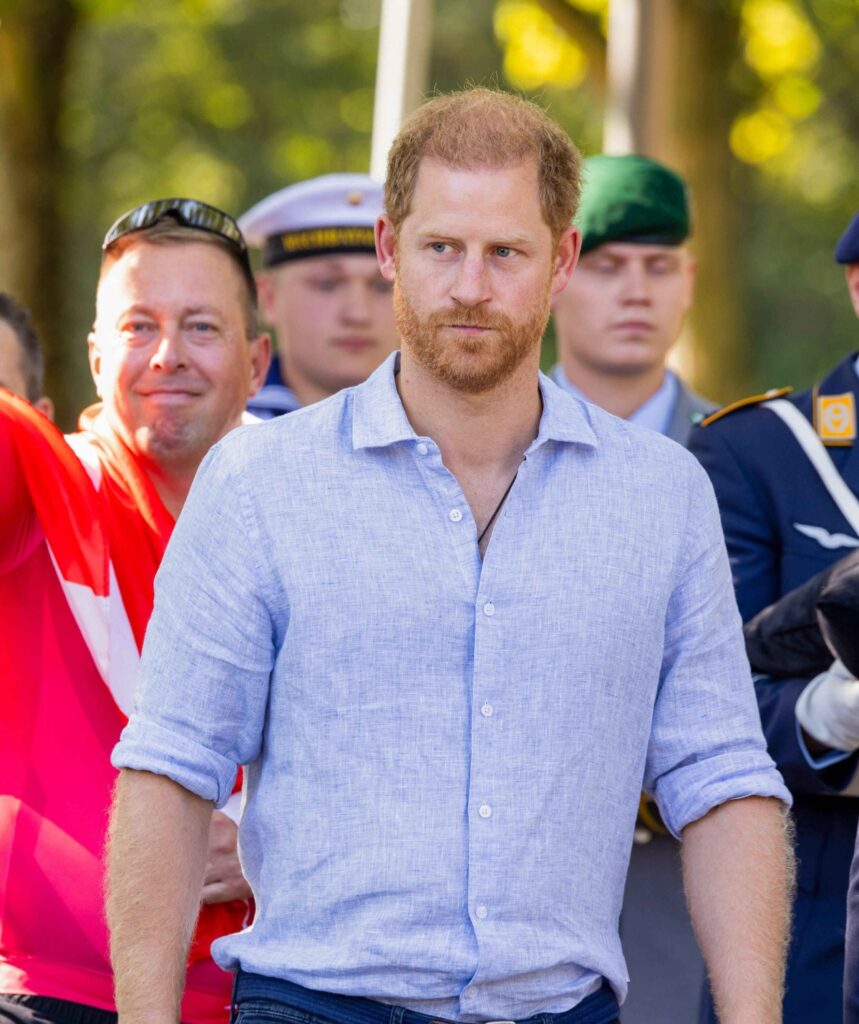 Prince Harry in a blue shirt.