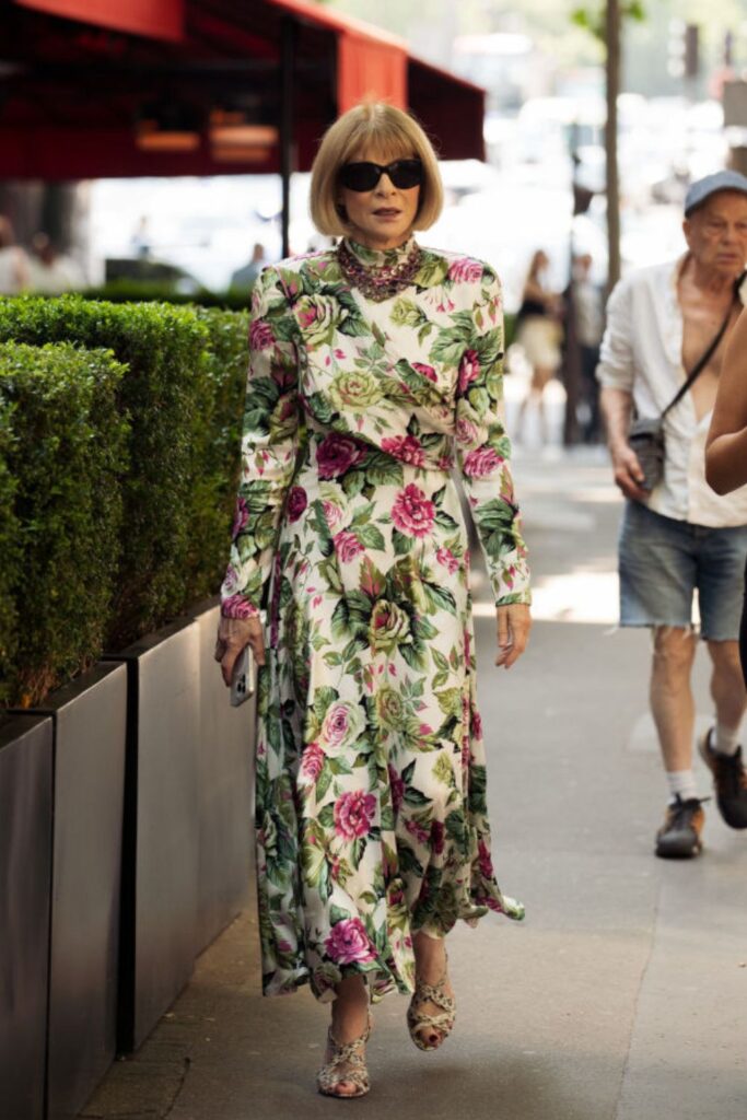 Anna Wintour wearing a stunning floral dress, heels and jewellery
