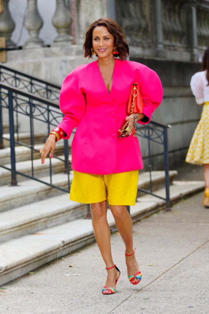 Nicole Ari Parker looking incredible in bold pink blouse and yellow skirt ensemble.  She also team red and multi-toned accessories to add to the look
