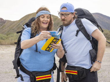 Brooke McClymont reads a clue to her husband Adam Eckersley, as the two compete in The Amazing Race.