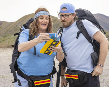 Brooke McClymont reads a clue to her husband Adam Eckersley, as the two compete in The Amazing Race.