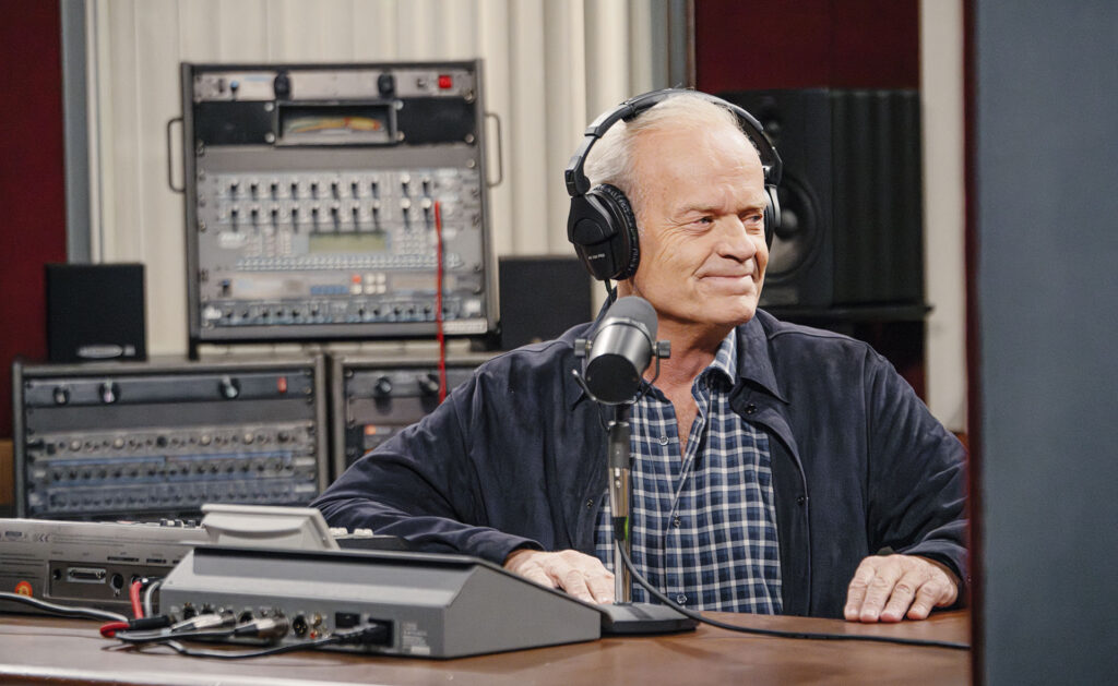 Frasier in a radio studio with headphones on.