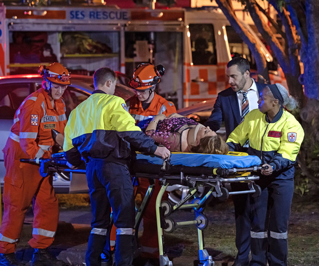 First responders wheel Terese away on a stretcher from the crash site