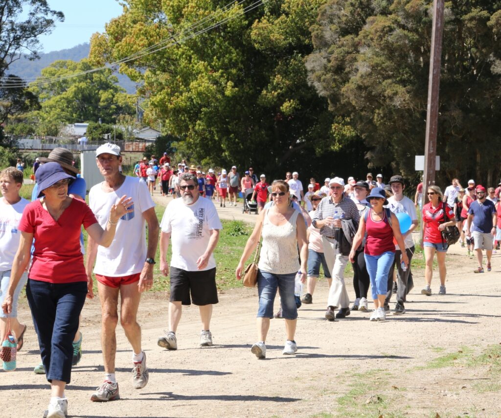 A group of people walking in a rural area.