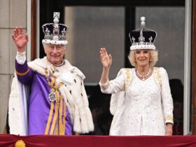 king charles and camilla wave wearing crowns