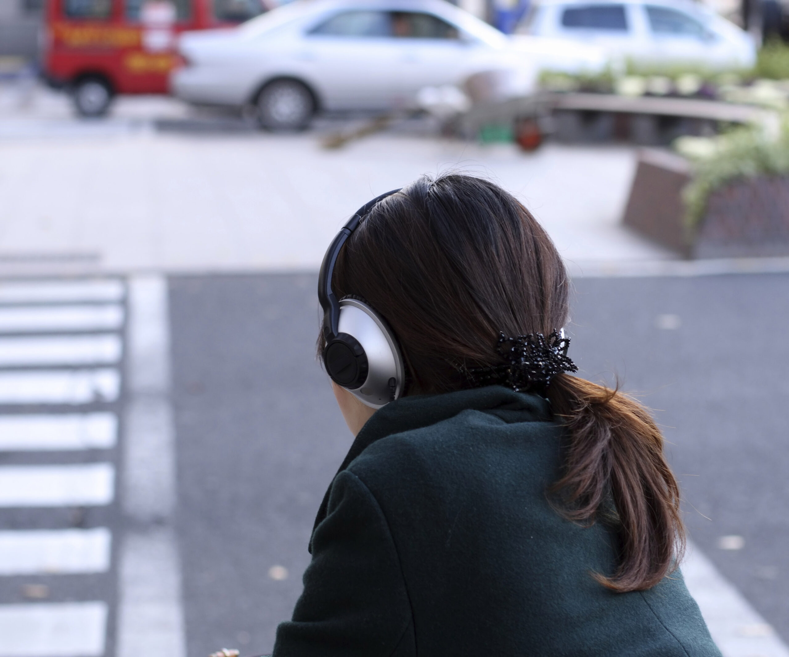 woman crossing road with headphones